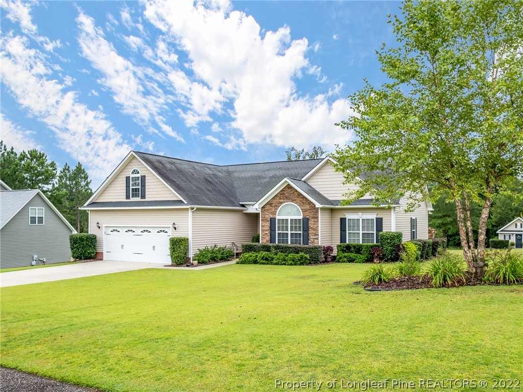 320 Porlock Way Raeford, NC 28376 - Photo 2 of 41 a front view of a house with garden