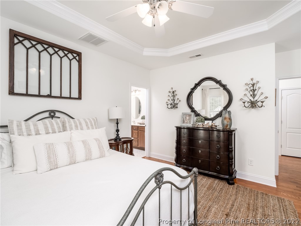 320 Porlock Way Raeford, NC 28376 - Photo 21 of 41 a bedroom with bed and wooden floor