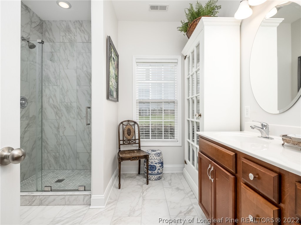 320 Porlock Way Raeford, NC 28376 - Photo 23 of 41 a bathroom with a sink and a mirror