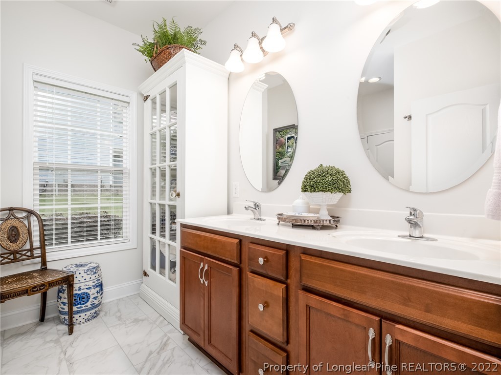 320 Porlock Way Raeford, NC 28376 - Photo 24 of 41 a bathroom with a double vanity sink and a mirror