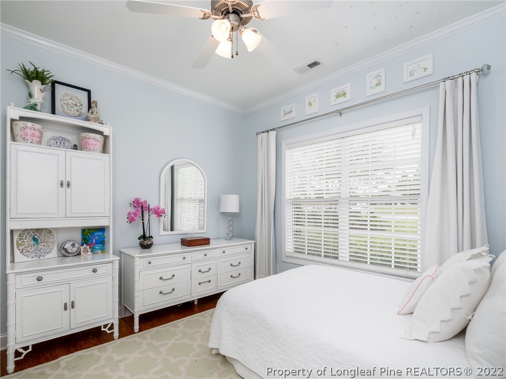 320 Porlock Way Raeford, NC 28376 - Photo 26 of 41 a bedroom with a bed and a dresser