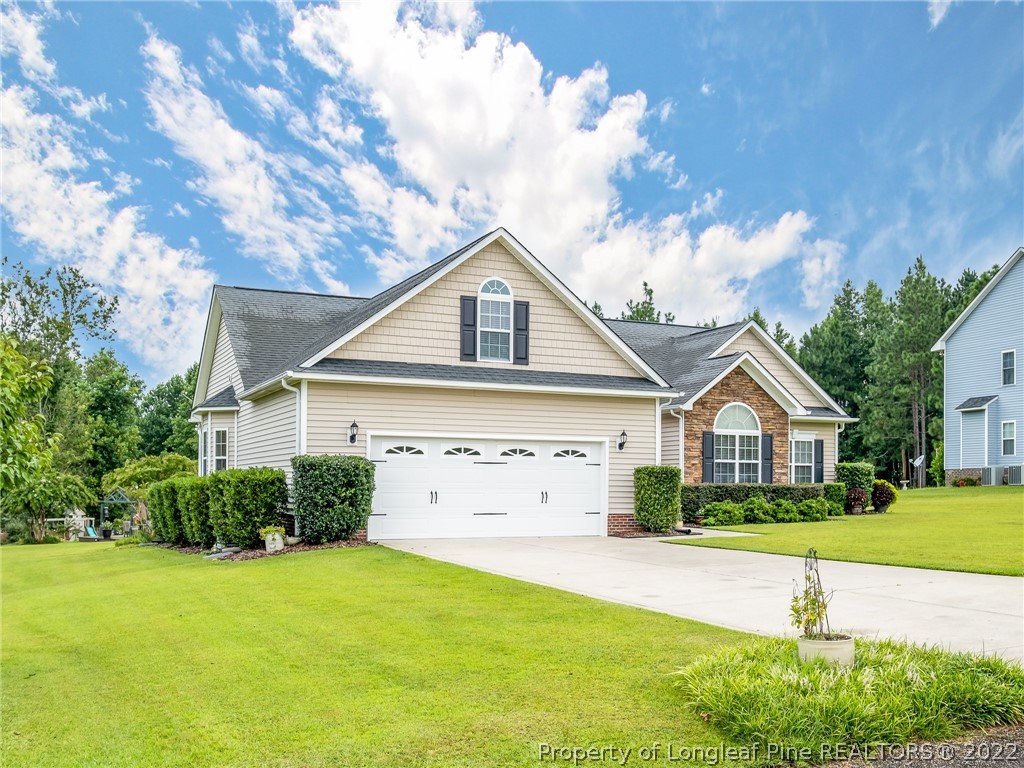 320 Porlock Way Raeford, NC 28376 - Photo 3 of 41 a front view of a house with a yard and garage