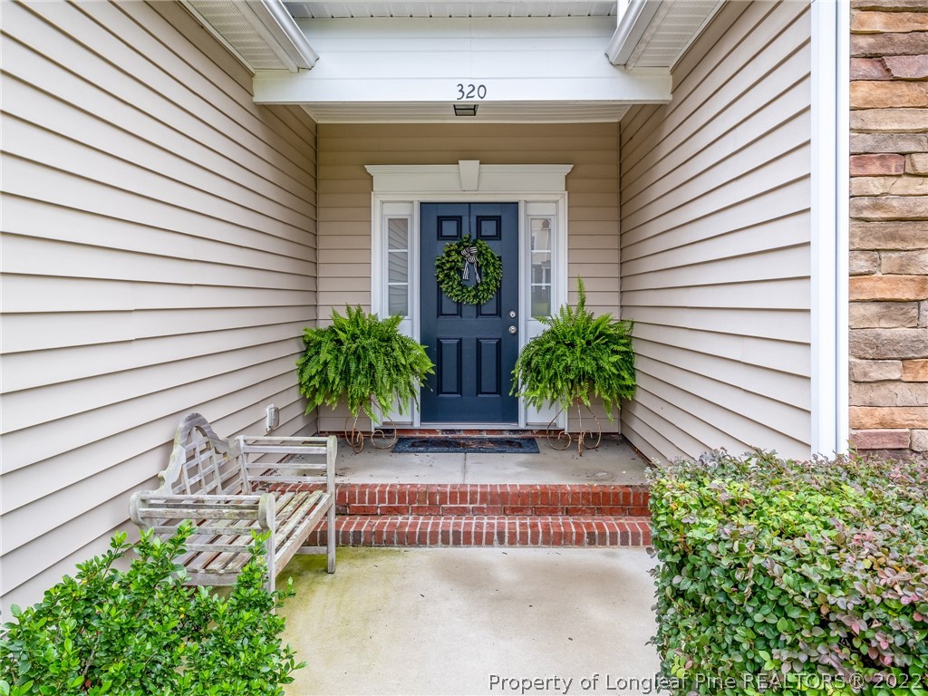 320 Porlock Way Raeford, NC 28376 - Photo 4 of 41 a front view of a house with a garden