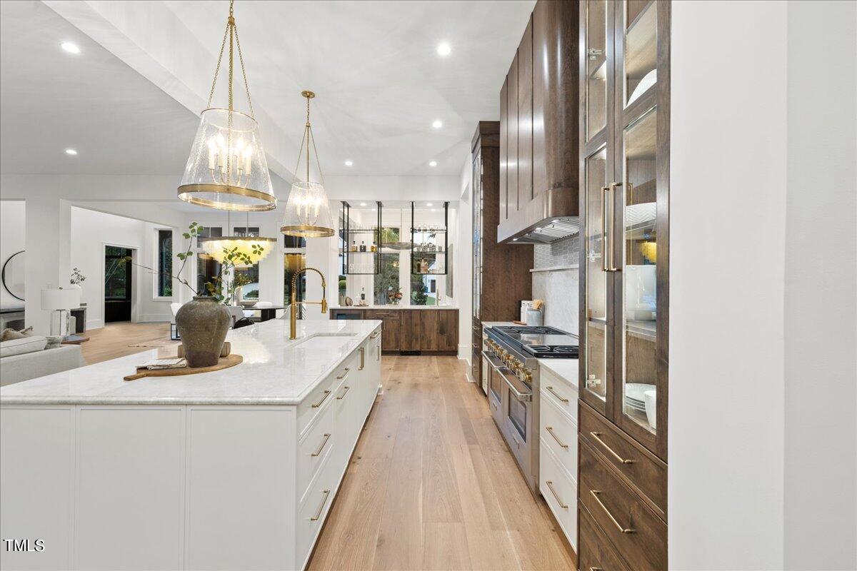 222 Reynolds Road Raleigh, NC 27609 - Photo 13 of 43 a view of a kitchen with kitchen island stainless steel appliances granite countertop lots of counter top space