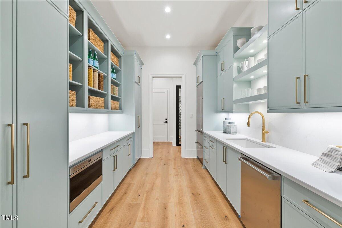 222 Reynolds Road Raleigh, NC 27609 - Photo 14 of 43 a large kitchen with a large counter top a sink a window and stainless steel appliances