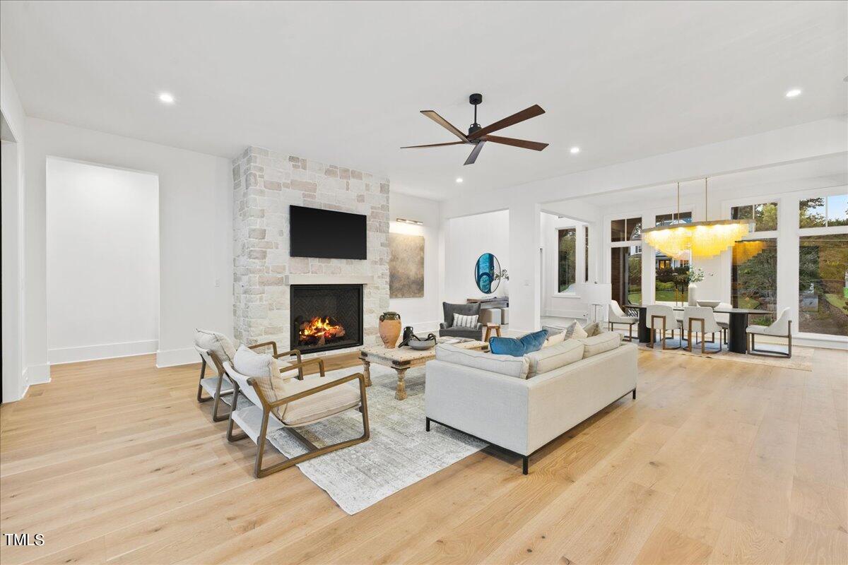 222 Reynolds Road Raleigh, NC 27609 - Photo 17 of 43 a living room with furniture a fireplace and a flat screen tv