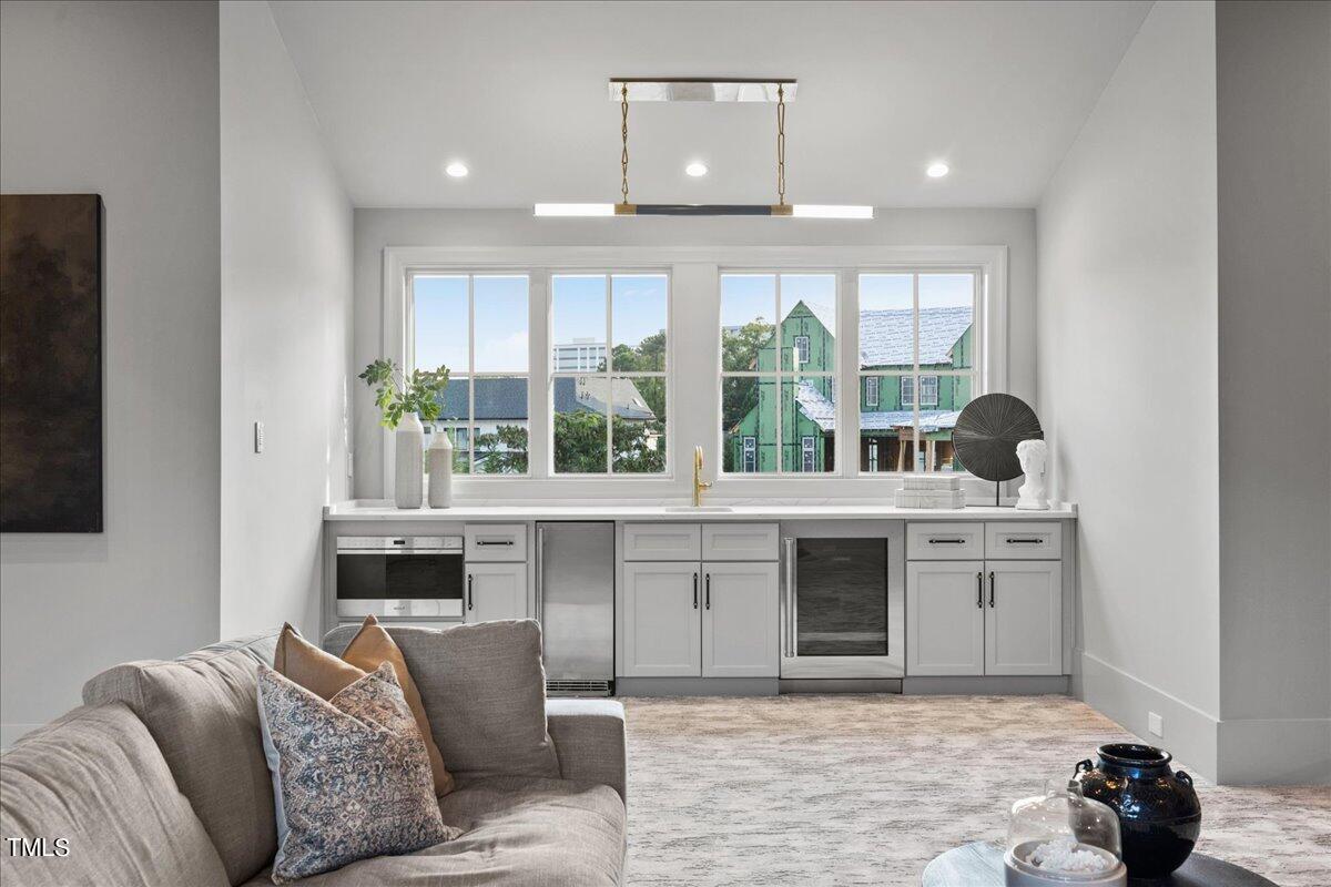 222 Reynolds Road Raleigh, NC 27609 - Photo 25 of 43 a living room with a large window and a fireplace