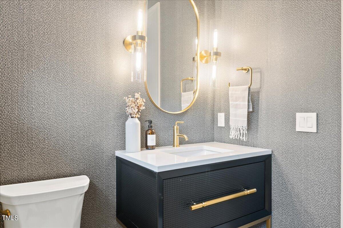 222 Reynolds Road Raleigh, NC 27609 - Photo 27 of 43 a bathroom with a sink and a mirror