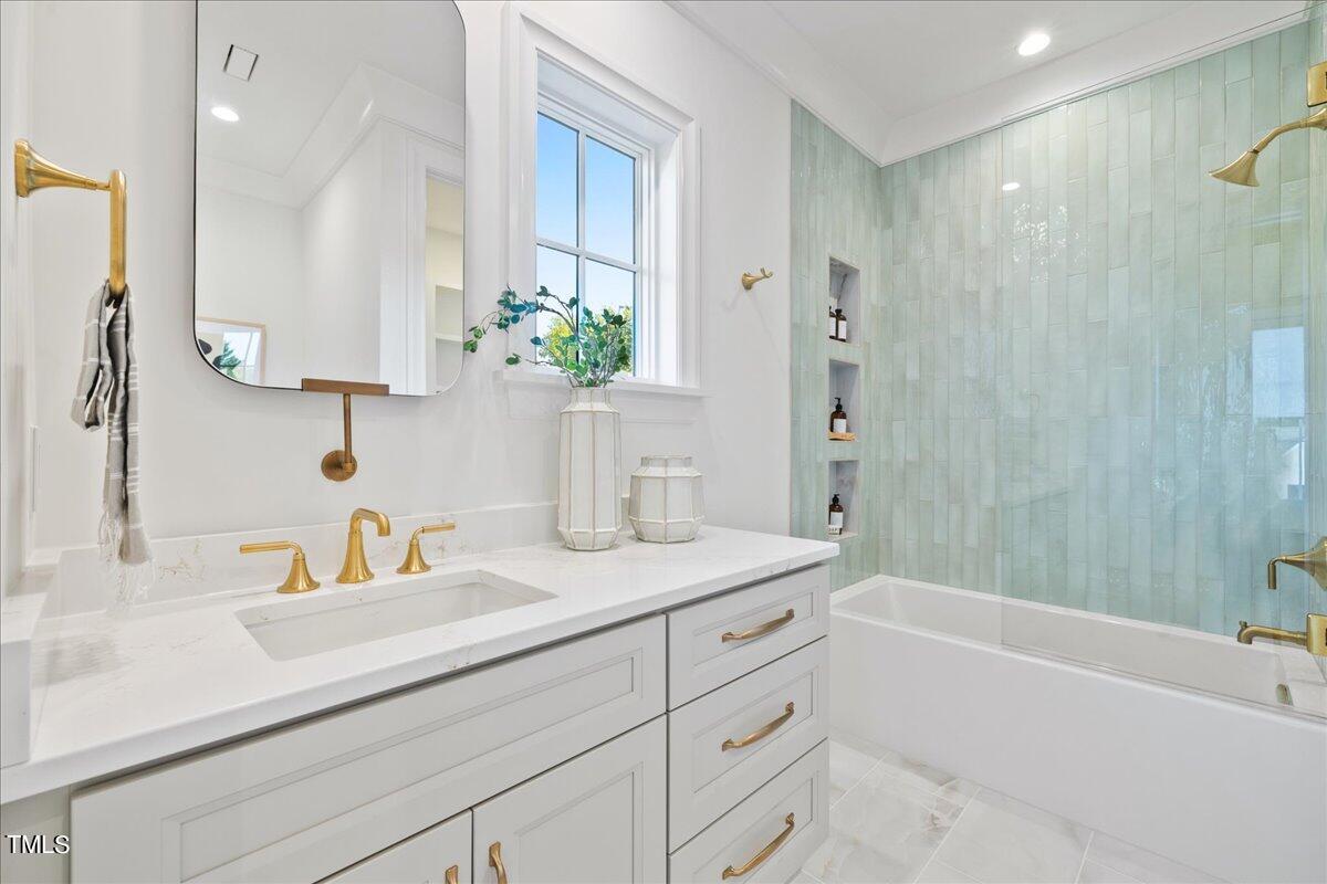 222 Reynolds Road Raleigh, NC 27609 - Photo 37 of 43 a bathroom with a sink tub shower and a mirror