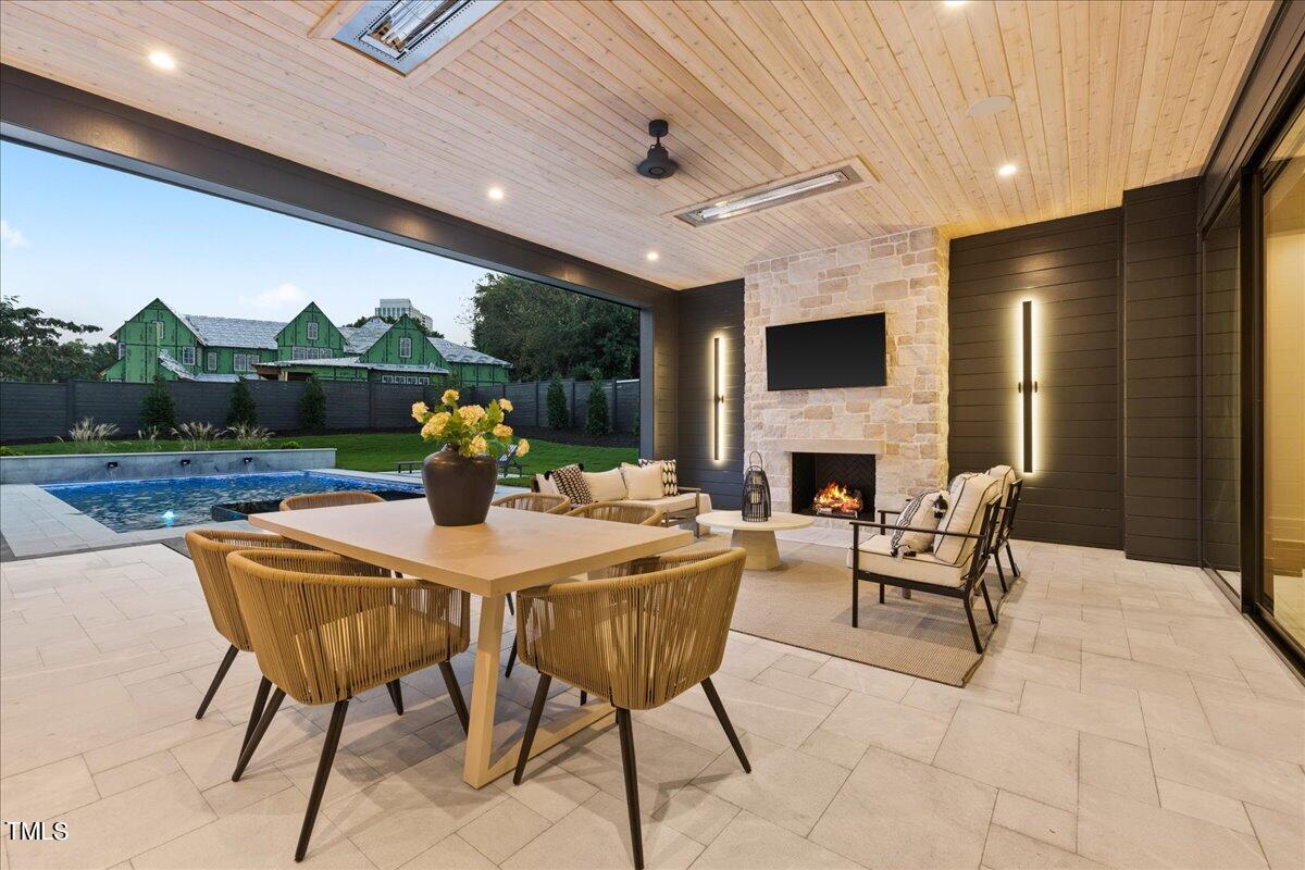 222 Reynolds Road Raleigh, NC 27609 - Photo 39 of 43 a view of a dining room with furniture window and a fireplace