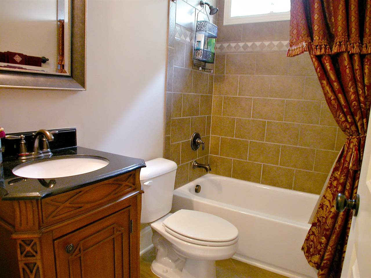 12349 Beestone Lane Raleigh, NC 27614 - Photo 16 of 25 Full bathroom on first floor has furniture vanity and tub with shower. Bathroom