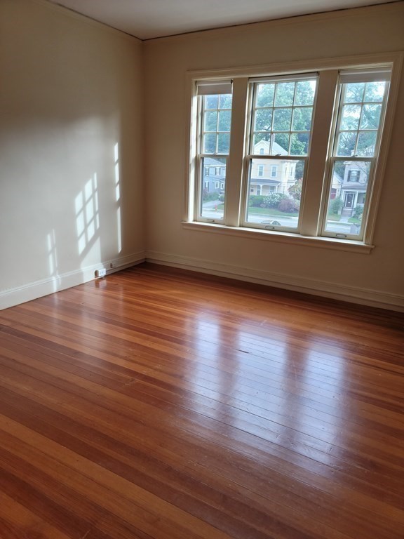 7 Lewis Road, Unit 2 Winchester, MA 01890 - Photo 9 of 13 a view of an empty room with wooden floor and a window