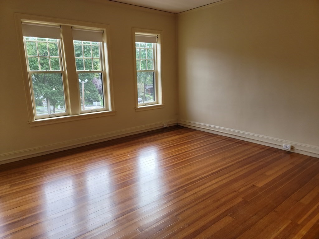 7 Lewis Road, Unit 2 Winchester, MA 01890 - Photo 10 of 13 a view of an empty room with wooden floor and a window