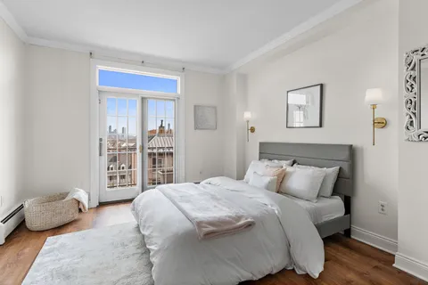 a bedroom with a bed and glass window