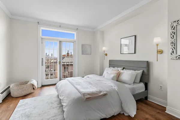 a bedroom with a bed and painting on the wall