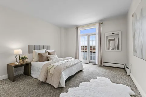 a bedroom with a bed and a night stand
