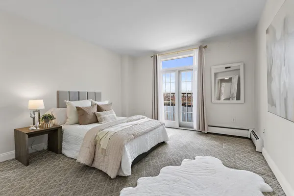 a bedroom with a bed and white walls
