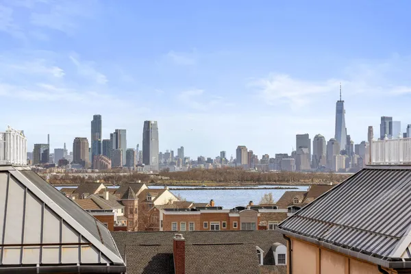a view of a roof deck with wooden fence