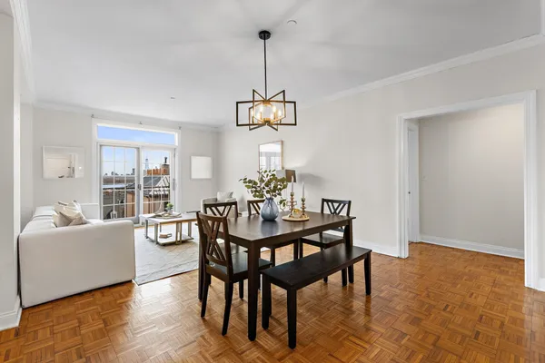 a living room with furniture and view of kitchen