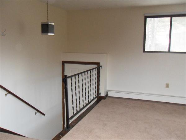 512-514 Gleasondale Road Stow, MA 01775 - Photo 9 of 16 a view of a livingroom with wooden floor and a window