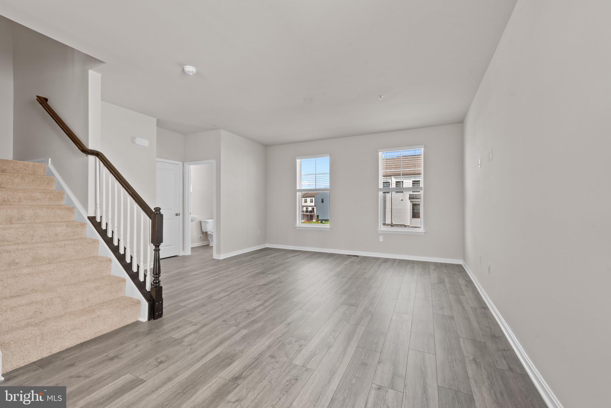 762 Union Street Frederick, MD 21701 - Photo 15 of 34 a view of an empty room with wooden floor and stairs