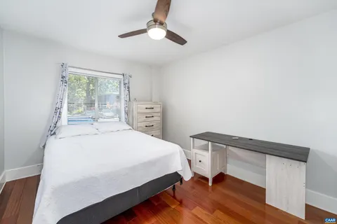 a bedroom with a bed a table and chair