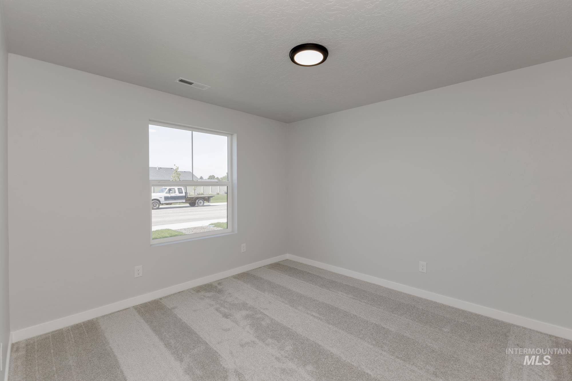 16366 Backfill Avenue Caldwell, ID 83607 - Photo 11 of 24 Unfurnished room featuring light colored carpet and baseboards
