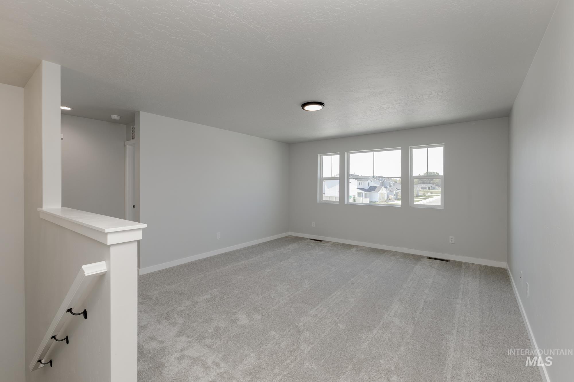 16366 Backfill Avenue Caldwell, ID 83607 - Photo 13 of 24 Spare room with light carpet and baseboards