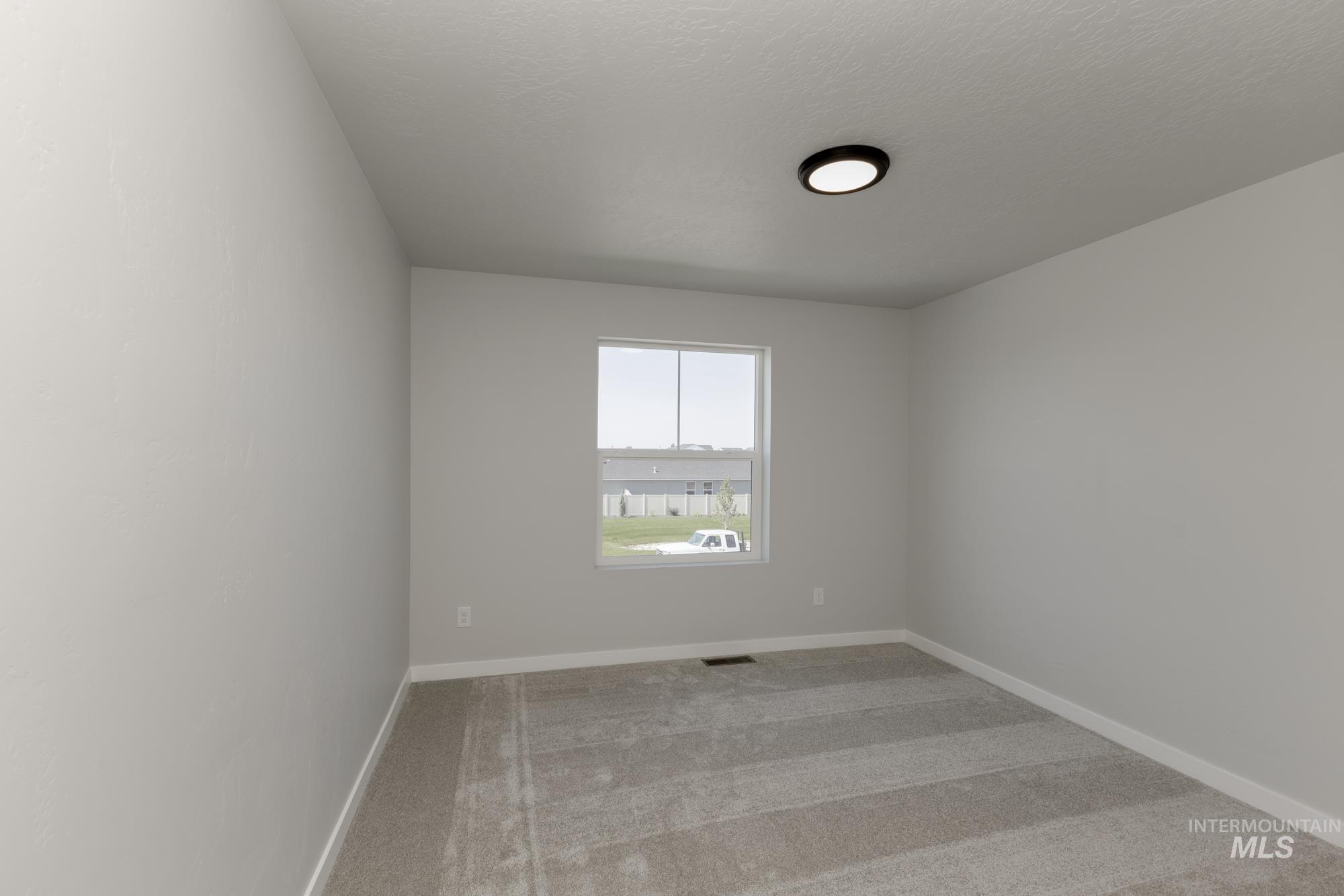 16366 Backfill Avenue Caldwell, ID 83607 - Photo 15 of 24 Spare room featuring light carpet and baseboards