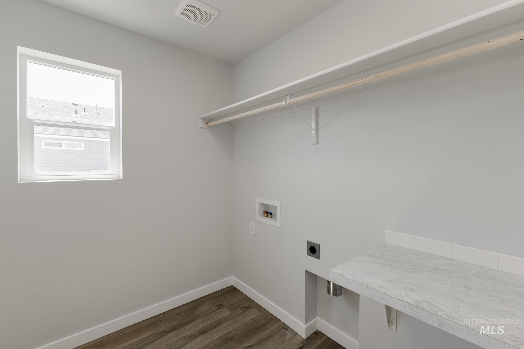 16366 Backfill Avenue Caldwell, ID 83607 - Photo 20 of 24 Laundry room with dark wood-type flooring, hookup for a washing machine, and electric dryer hookup