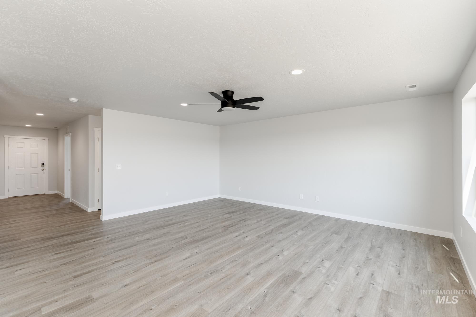 16366 Backfill Avenue Caldwell, ID 83607 - Photo 9 of 24 Spare room with light wood-style flooring, recessed lighting, and ceiling fan