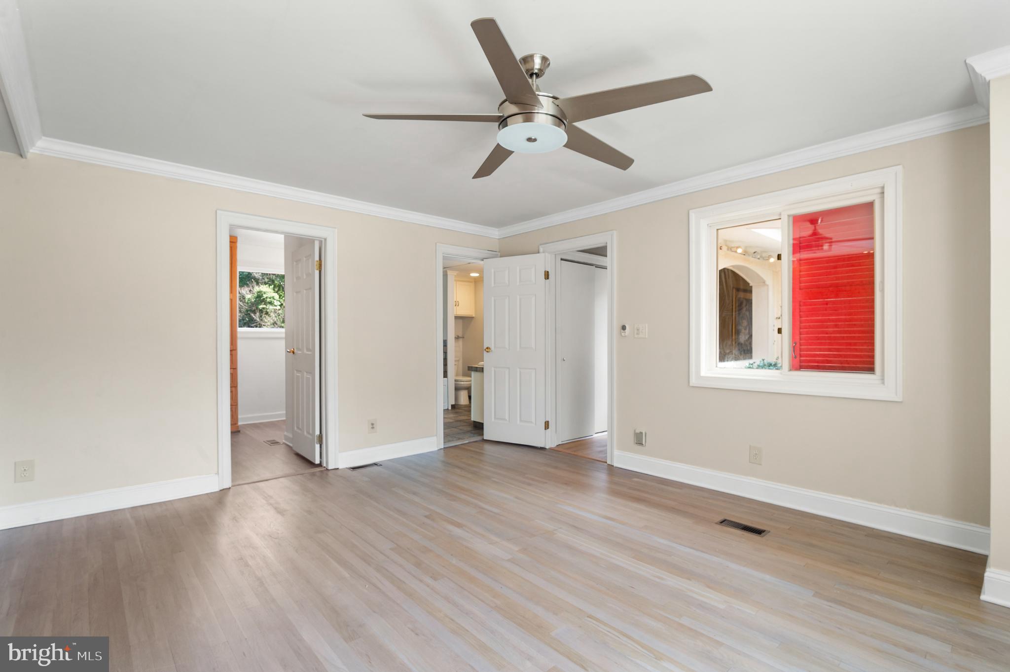 15729 Holly Grove Road Silver Spring, MD 20905 - Photo 46 of 83 a view of an empty room with wooden floor and a window