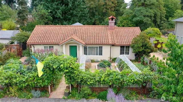 a front view of a house with a garden