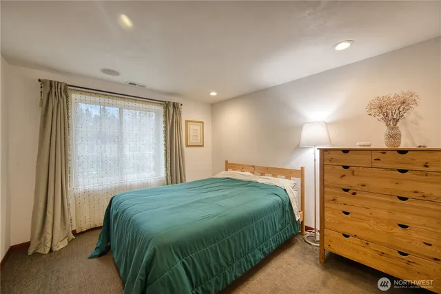 a bedroom with a bed and a dresser