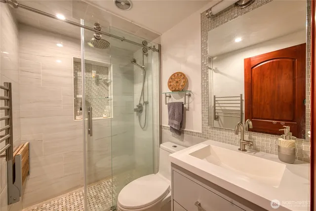 a bathroom with a sink toilet and shower