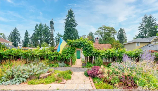 a backyard of a house with lots of green space and lake view