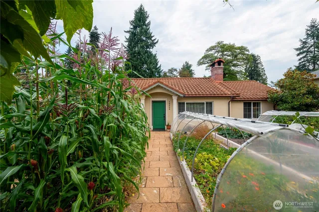 an aerial view of a house with yard and green space