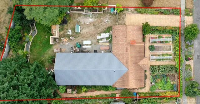 a aerial view of a house with a yard and potted plants