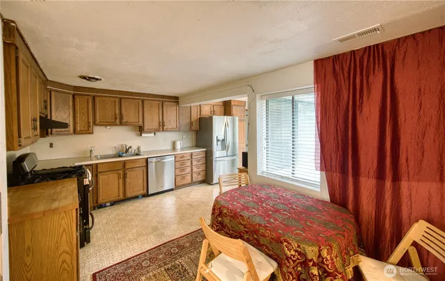 a kitchen with a refrigerator sink and cabinets
