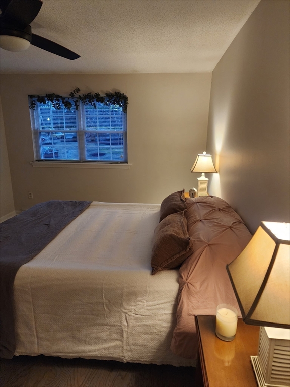 20 Hemlock Circle, Unit 20 Millis, MA 02054 - Photo 12 of 24 a bed sitting in a bedroom next to a lamp