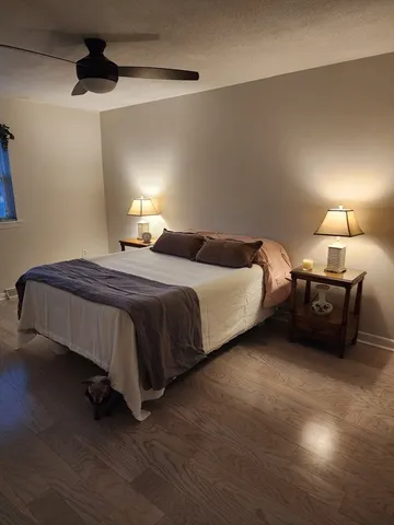 a bedroom with a bed and a lamp