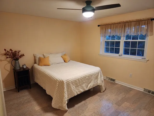 a bedroom with a bed and window