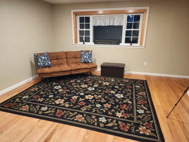 a living room with a couch and a stove top oven