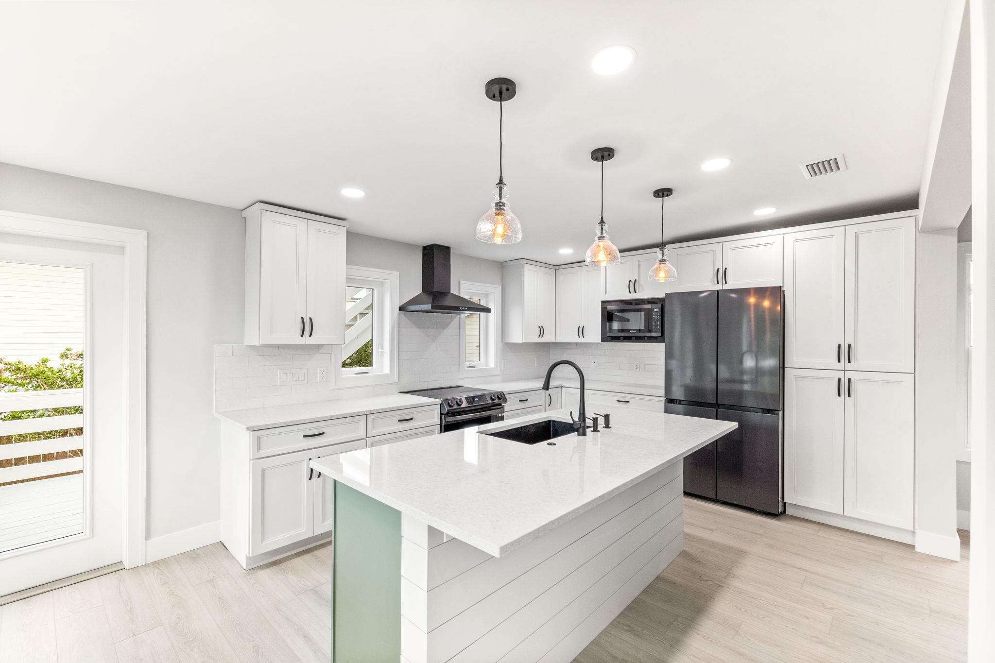 5348 Pelican Way St. Augustine, FL 32080 - Photo 11 of 46 a kitchen with stainless steel appliances a sink a stove a refrigerator and island