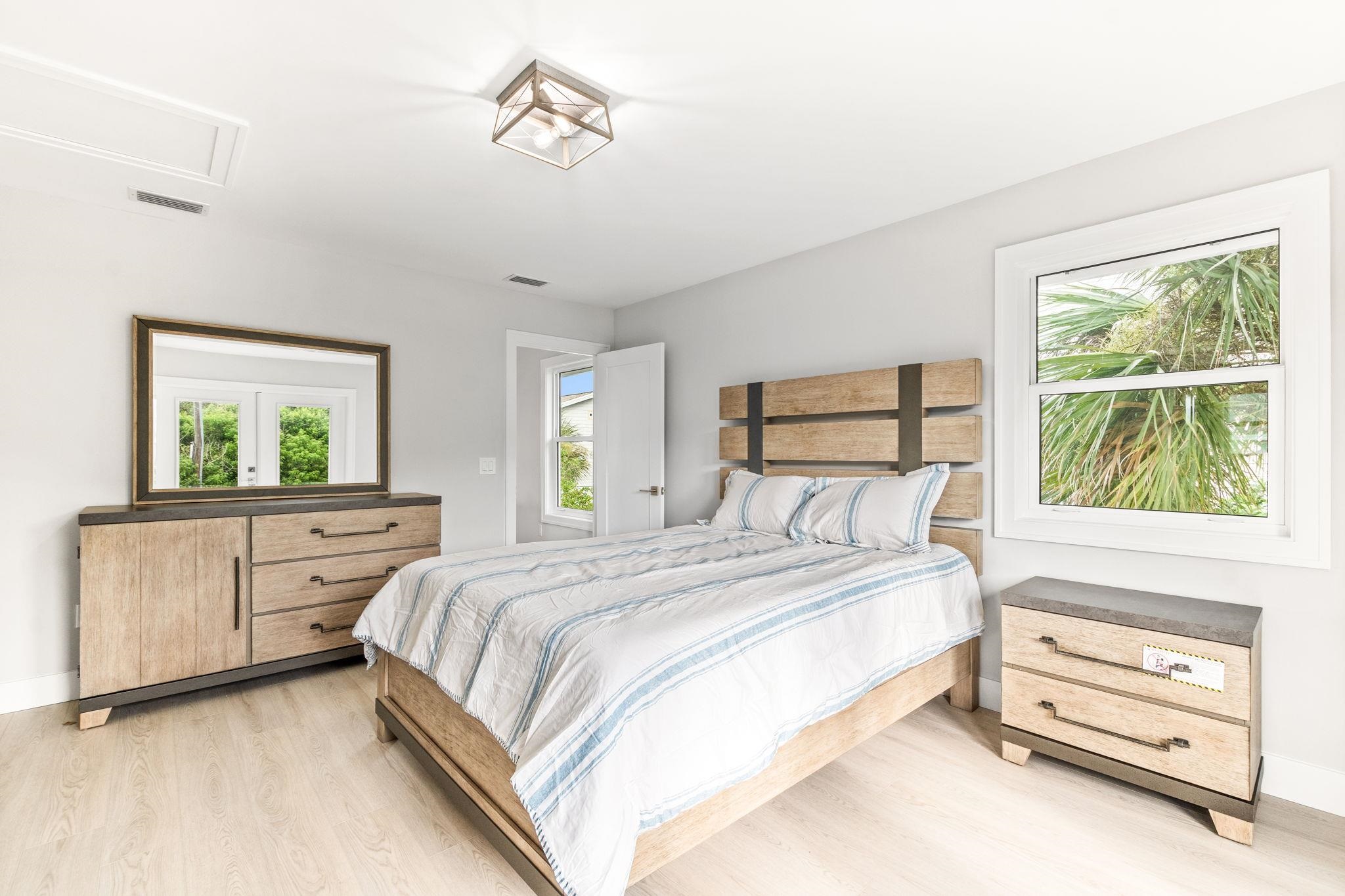 5348 Pelican Way St. Augustine, FL 32080 - Photo 14 of 46 a bedroom with a bed and a dresser next to a window