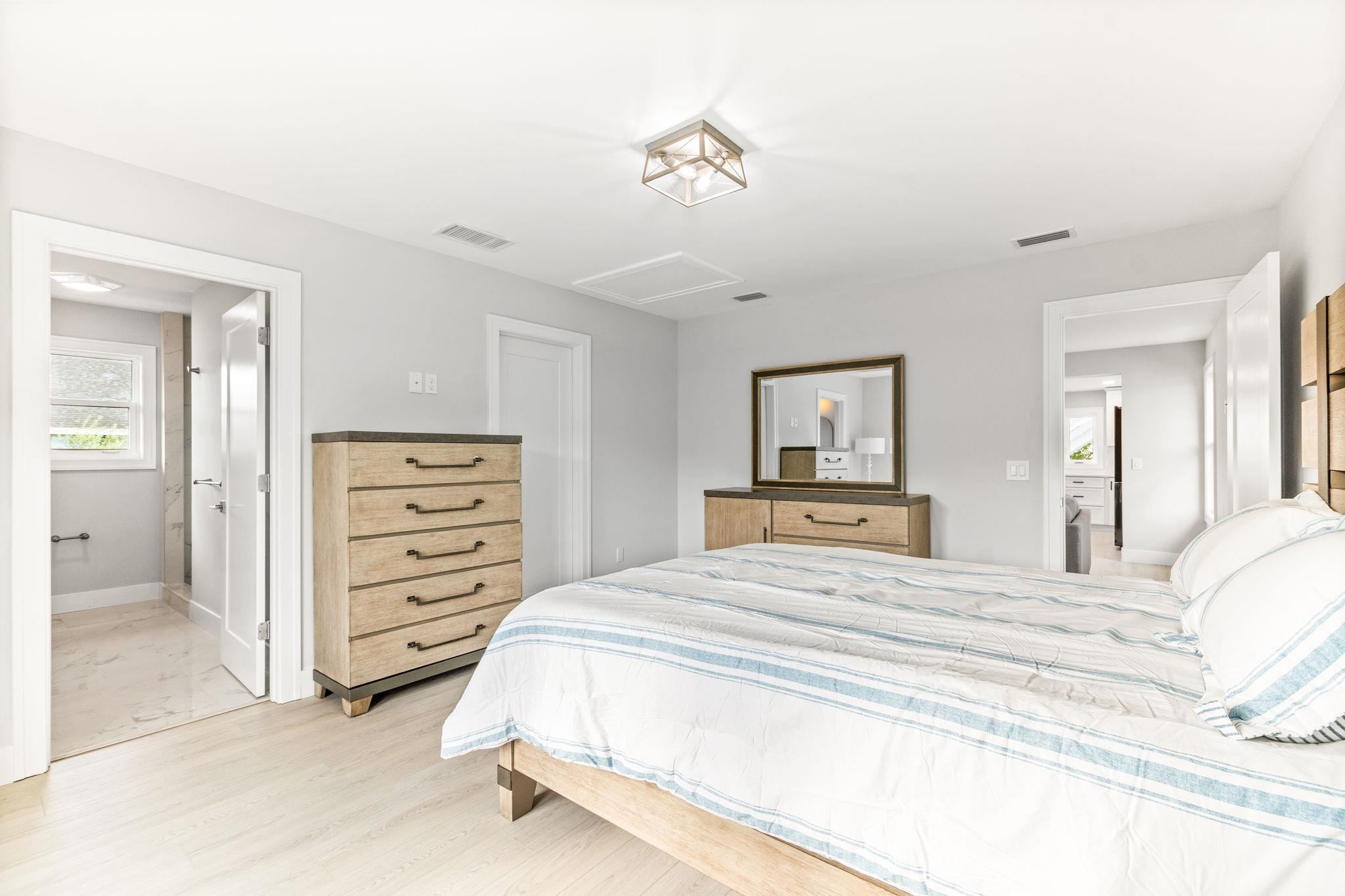 5348 Pelican Way St. Augustine, FL 32080 - Photo 15 of 46 a bedroom with a bed and a chandelier