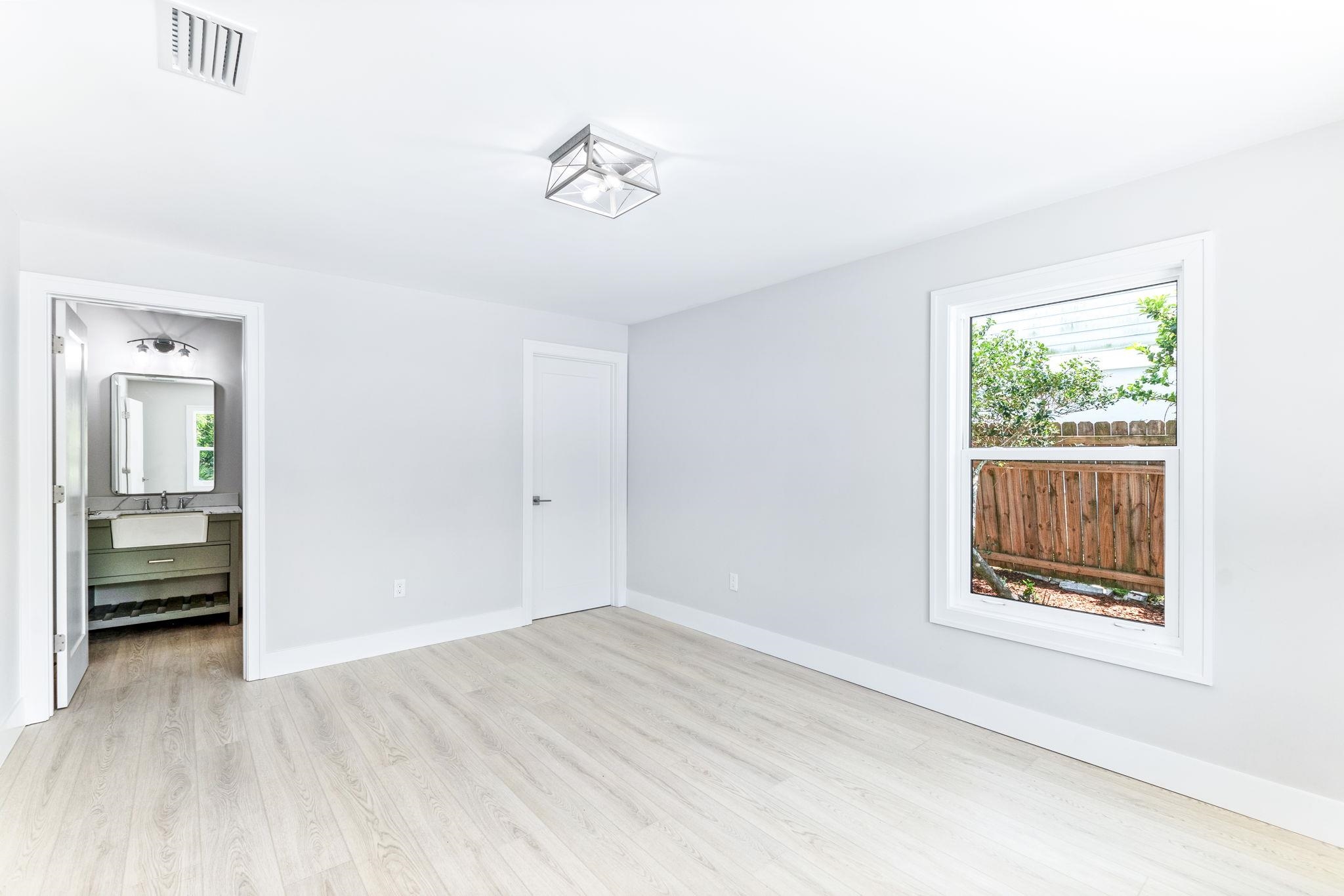 5348 Pelican Way St. Augustine, FL 32080 - Photo 22 of 46 a view of an empty room with wooden floor and a window
