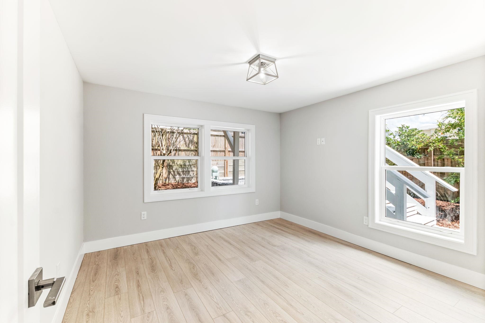 5348 Pelican Way St. Augustine, FL 32080 - Photo 26 of 46 wooden floor in an empty room with a window