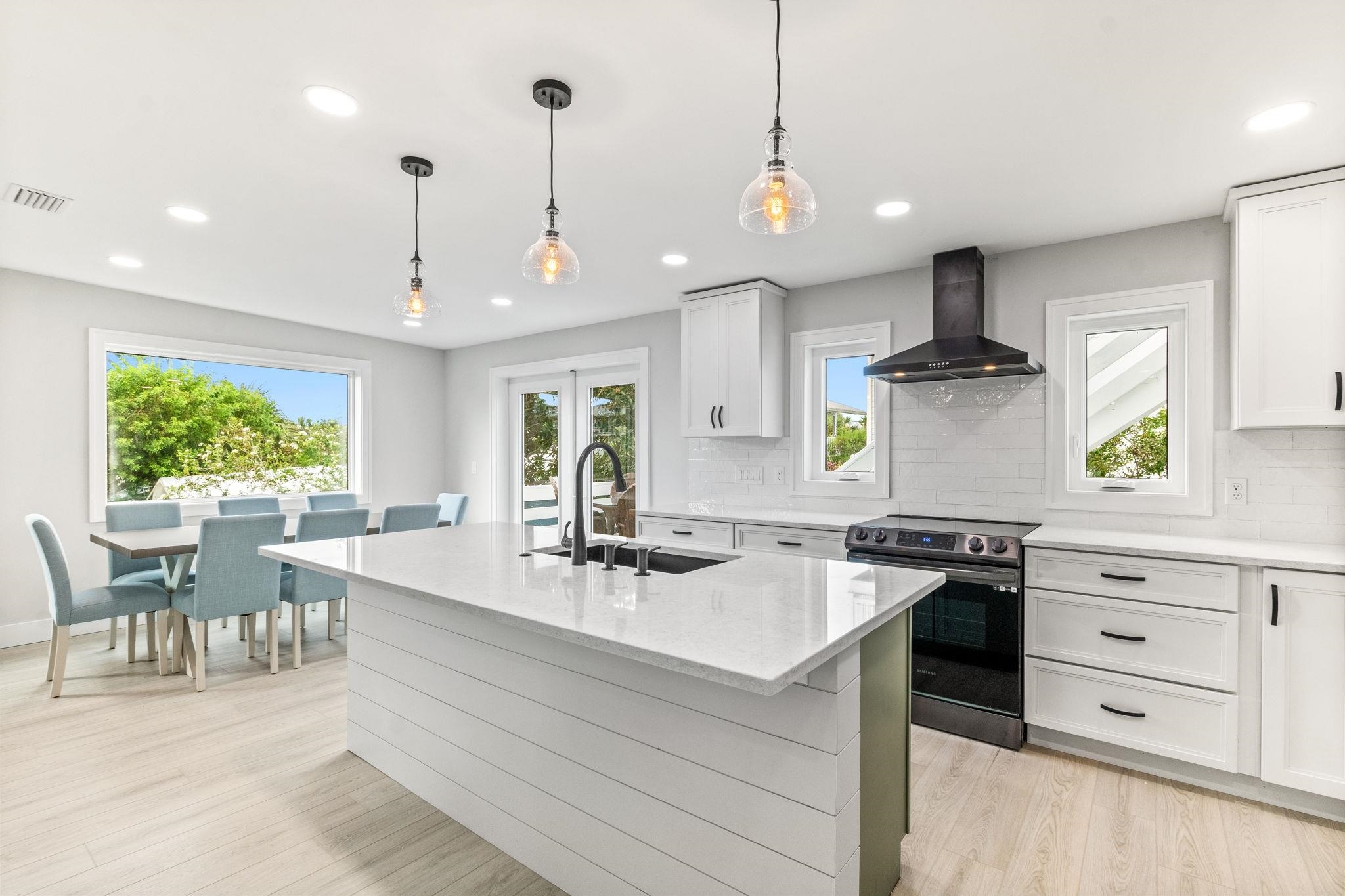 5348 Pelican Way St. Augustine, FL 32080 - Photo 8 of 46 a kitchen with stainless steel appliances granite countertop a sink a stove and a wooden floors