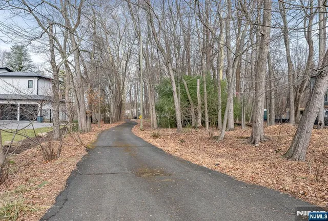 a view of a house with trees in the background